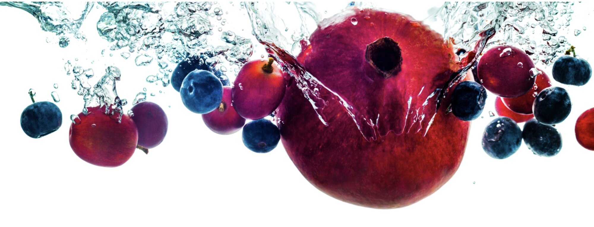 Fresh superfruits splashing into water